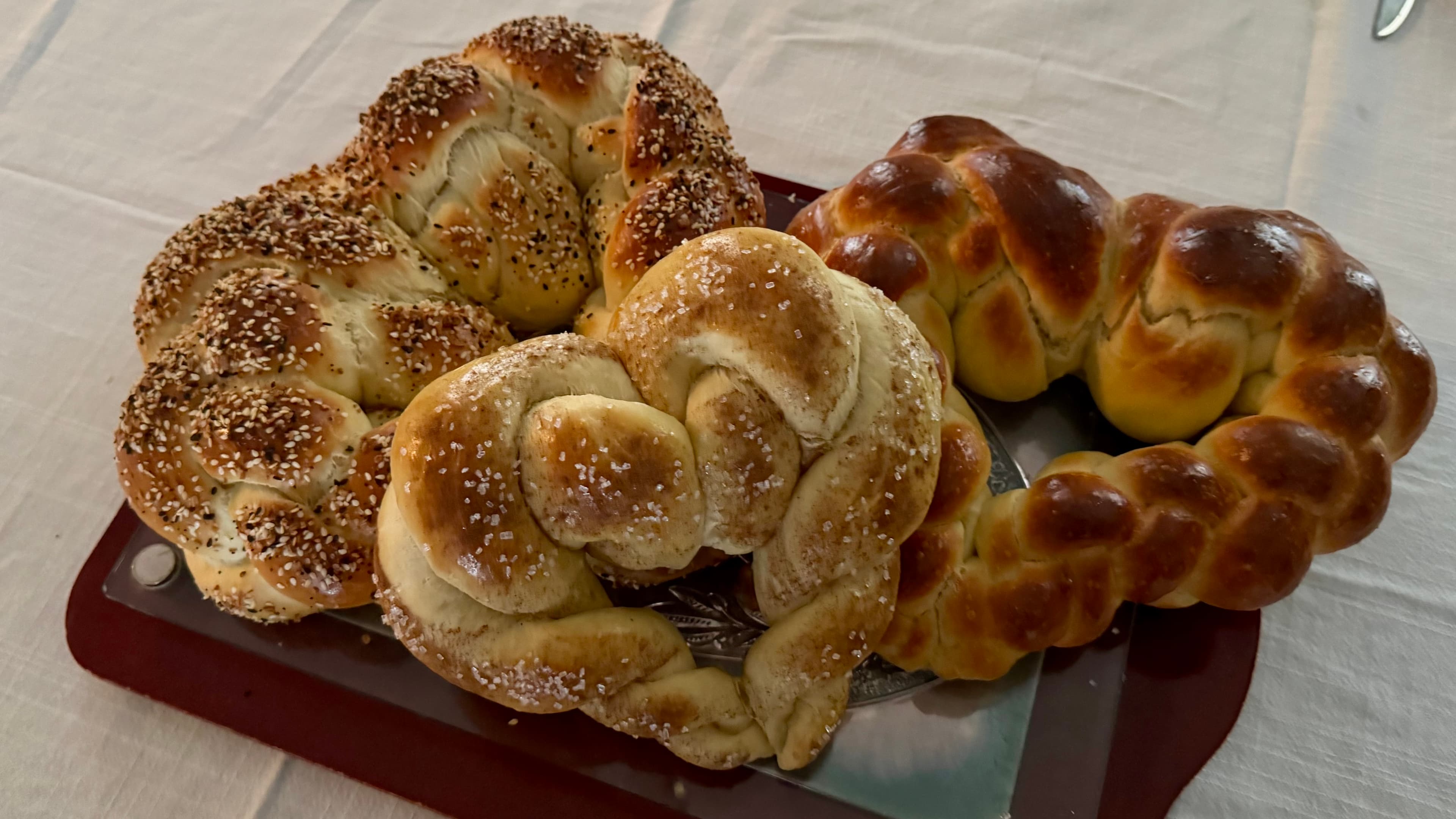 Heart-shaped challah loaves on a board